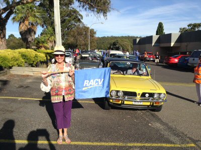 Denise Drysdale flags off car number 001 for the 2014 rally